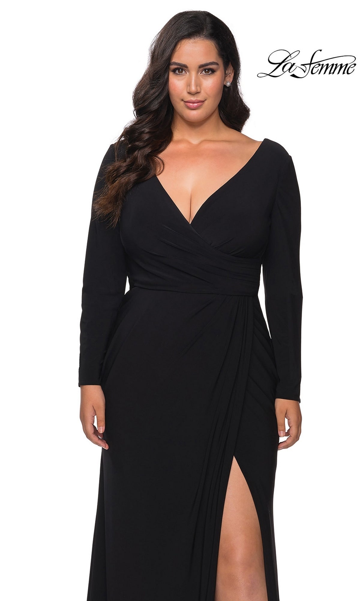 A woman wears a black, long-sleeve Long Plus-Size Prom Dress: La Femme 29044 with a V-neckline, a faux wrap bodice, and a high side slit.